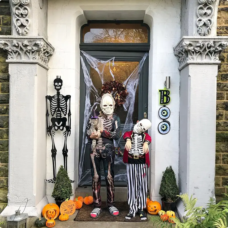 Skeletons in Costume Guarding the Door