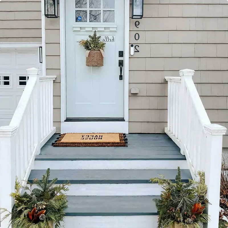 Beige Siding, Layered Doormats, and a Porch That Feels Like Home