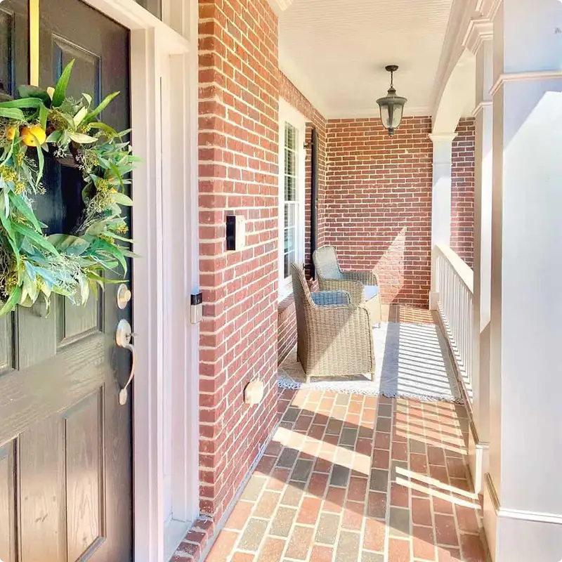 Brick Steps With a Timeless White Railing Touch