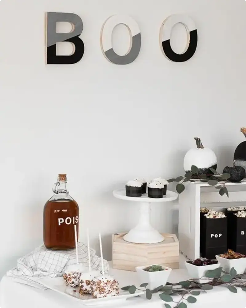 Cool Halloween Vibes with Colorful Letters, Black & White Pumpkins, and Popcorn Snacks