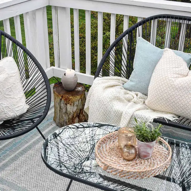 Cozy Black Patio Set Styled up Against Crisp White Porch Rails