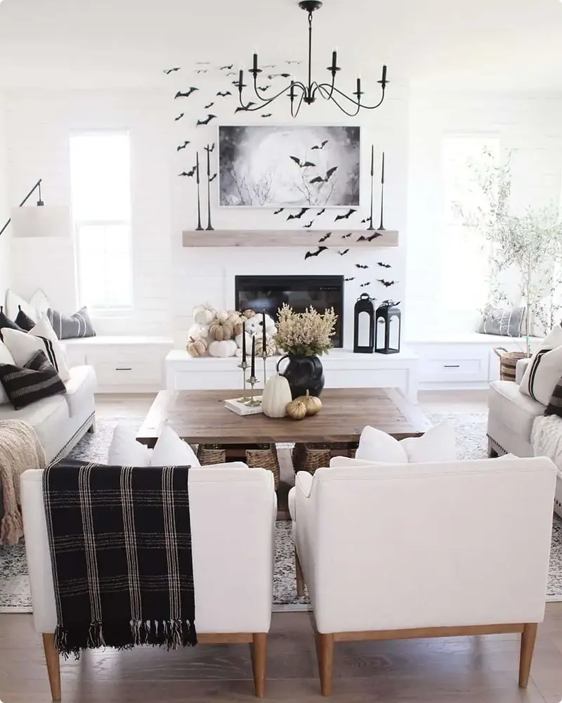 Seating Area Around White Shiplap Fireplace and Paper Bats
