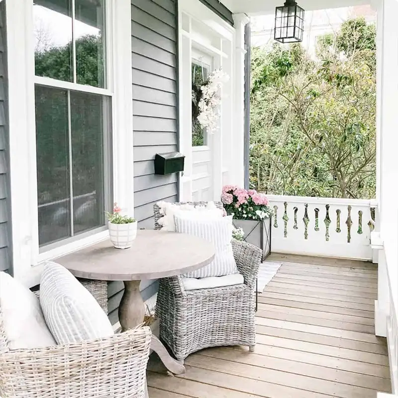 White Porch Railing and Wicker Chairs