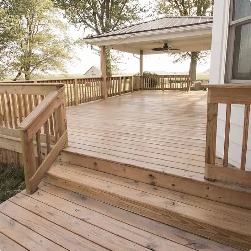 Wooden Deck Meets Matching Wood Railings for a Seamless Farmhouse Look