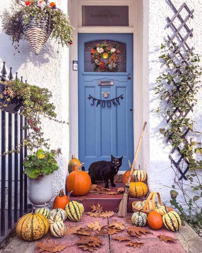 Porch Display with Pumpkins and a Black Cat